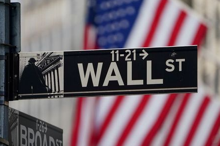 FILE PHOTO: The Wall Street sign is pictured at the New York Stock exchange (NYSE) in the Manhattan borough of New York City, New York, U.S., March 9, 2020. REUTERS/Carlo Allegri