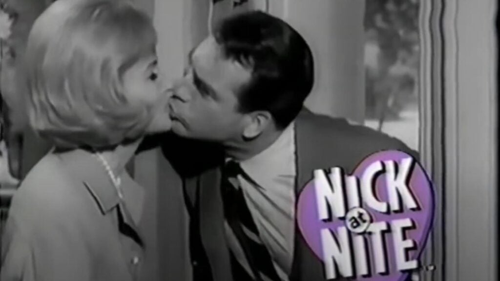 Donna Reed as Donna Stone kisses her husband, Alex Stone (Carl Betz) as he leaves for work in this scene from the opening title sequence of The Donna Reed Show.