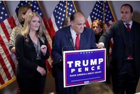 Trump Campaign Senior Legal Advisor Jenna Ellis speaks as Trump campaign advisor Boris Epshteyn reaches out to former New York City Mayor Rudy Giuliani, personal attorney to U.S. President Donald Trump, during a news conference about the 2020 U.S. presidential election results at Republican National Committee headquarters in Washington, U.S., November 19, 2020. REUTERS/Jonathan Ernst