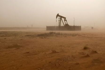 A pump jack lifts oil out of a well, during a sandstorm in Midland, Texas, U.S., April 13, 2018. Picture taken April 13, 2018. REUTERS/Ann Saphir