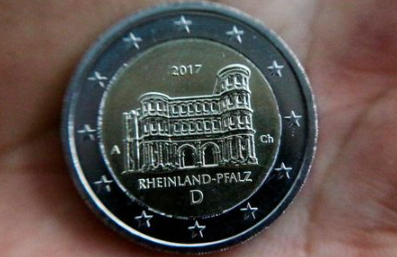 FILE PHOTO: A newly designed 2-Euro coin is pictured during a presentation at the Chancellery in Berlin, Germany February 10, 2017. REUTERS/Hannibal Hanschke/File Photo
