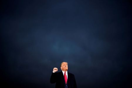 U.S. President Donald Trump makes a fist during a campaign rally at Des Moines International Airport in Des Moines, Iowa, U.S., October 14, 2020. REUTERS/Carlos Barria