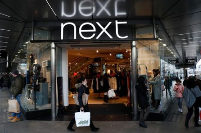 FILE PHOTO: Pedestrians walk past a Next store in central London, Britain January 3, 2017. REUTERS/Stefan Wermuth