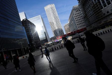 People walk during the morning rush hour in the financial district of Canary Wharf amid the outbreak of the coronavirus disease (COVID-19) in London, Britain September 28, 2020. REUTERS/Toby Melville