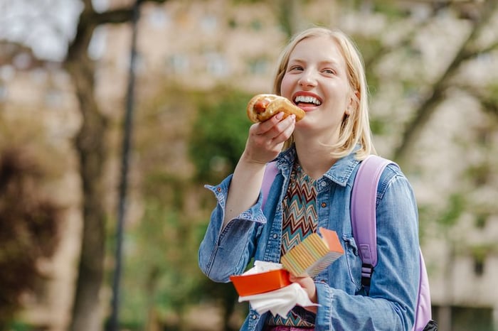 Young woman eating a hotdog