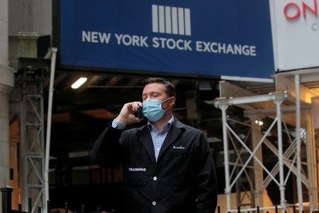 Trader Frank Masiello talks on his phone on Wall St. outside the New York Stock Exchange (NYSE) in New York, U.S., January 15, 2021. REUTERS/Brendan McDermid