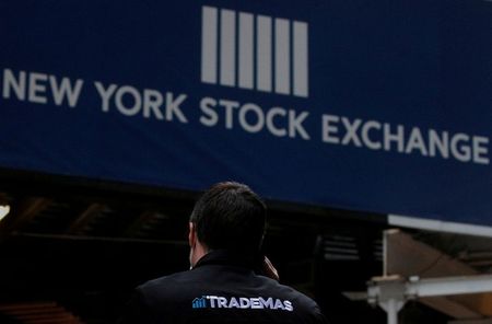 FILE PHOTO: Trader Frank Masiello talks on his phone on Wall St. outside the New York Stock Exchange (NYSE) in New York, U.S., January 15, 2021. REUTERS/Brendan McDermid/File Photo