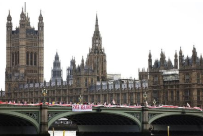 Demonstrators hang the flag of Belarus from Westminster Bridge for the Global Solidarity Event for Belarus protest in London, Britain, August 8, 2021. REUTERS/Henry Nicholls