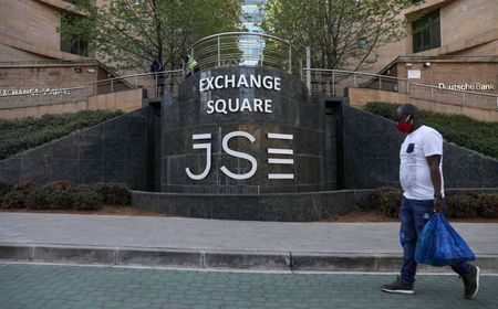 FILE PHOTO: A man walks past the Johannesburg Stock Exchange (JSE), as the coronavirus disease (COVID-19) lockdown regulations are eased in Sandton, South Africa, September 10, 2020. REUTERS/Siphiwe Sibeko/File Photo