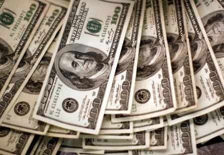 U.S. dollars are counted out by a banker counting currency at a bank in Westminster, Colorado November 3, 2009. REUTERS/Rick Wilking