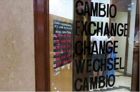A board displays the Brazilian Real-U.S. dollar and other exchange rates, following the spread of the coronavirus, in Sao Paulo, Brazil, March 5, 2020. REUTERS/Rahel Patrasso