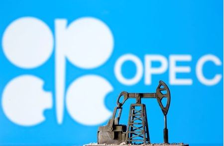 A 3D printed oil pump jack is seen in front of displayed Opec logo in this illustration picture, April 14, 2020. REUTERS/Dado Ruvic/Illustration