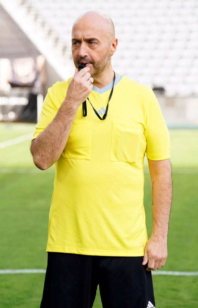 Joe Bastianich blows a whistle during the field challenge.