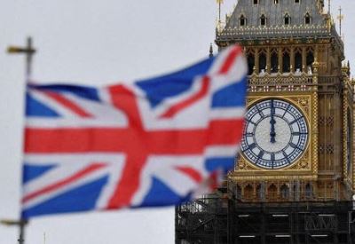A clock face is seen at midday on Elizabeth Tower, more commonly known as the Big Ben, ahead of New Year's Eve events when all four faces will be visible for first time to ring in the new year since restoration works commenced in 2017 at the Houses of Parliament, in London, Britain, December 29, 2021. REUTERS/Toby Melville