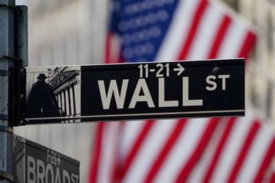 FILE PHOTO: The Wall Street sign is pictured at the New York Stock exchange (NYSE) in the Manhattan borough of New York City, New York, U.S., March 9, 2020. REUTERS/Carlo Allegri/File Photo