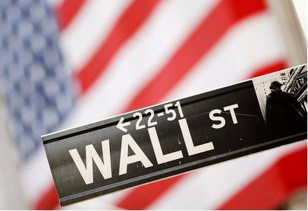 A Wall Street sign is seen outside the New York Stock Exchange, September 30, 2008. REUTERS/Lucas Jackson/File Photo