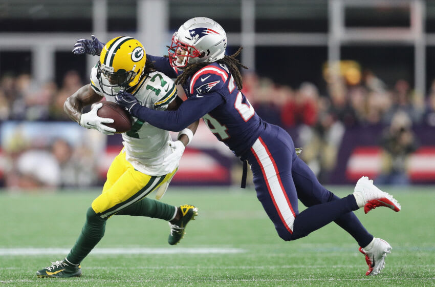 FOXBOROUGH, MA - NOVEMBER 04: Stephon Gilmore #24 of the New England Patriots tackles Davante Adams #17 of the Green Bay Packers during the first half at Gillette Stadium on November 4, 2018 in Foxborough, Massachusetts. (Photo by Maddie Meyer/Getty Images)