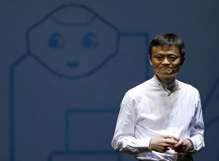 FILE PHOTO: Jack Ma, founder and executive chairman of China's Alibaba Group, speaks in front of a picture of SoftBank's human-like robot named 'pepper' during a news conference in Chiba, Japan, June 18, 2015. REUTERS/Yuya Shino 