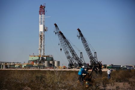 An oil worker drives a forklift truck towards a drill rig after placing some ground monitoring equipment in the vicinity of the underground horizontal drill in Loving County, Texas, U.S. November 22, 2019. Picture taken November 22, 2019. REUTERS/Angus Mordant