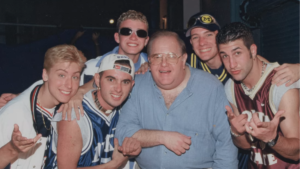 A screenshot from the Dirty Pop: The Boy Band Scam documentary featuring Lou Pearlman and *NSYNC.
