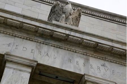 An eagle tops the U.S. Federal Reserve building's facade in Washington, July 31, 2013. The U.S. Federal Reserve likely will decide at the end of a policy meeting on Wednesday to continue buying bonds at an $85 billion monthly pace, but it could alter an accompanying statement to spell out the possibility of scaling back purchases later this year. REUTERS/Jonathan Ernst (UNITED STATES - Tags: POLITICS BUSINESS)