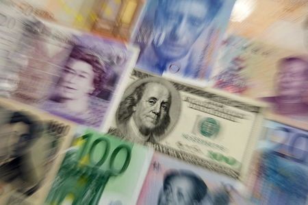 Arrangement of various world currencies including Chinese Yuan, Japanese Yen, US Dollar, Euro, British Pound, Swiss Franc are pictured in Warsaw January 26, 2011. REUTERS/Kacper Pempel (POLAND - Tags: BUSINESS)