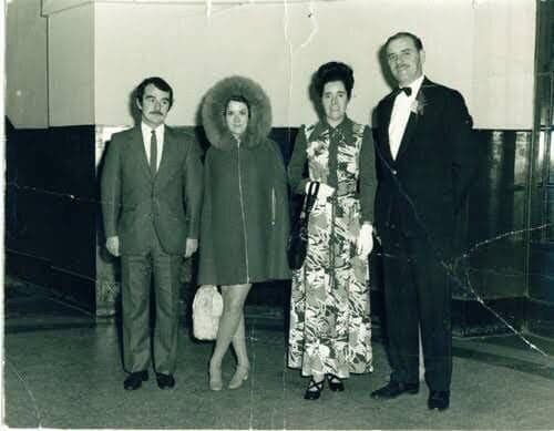 This photo was taken in 1972, and shows four guests at a wedding. Just four guests posing for a photo at a wedding. Except...what