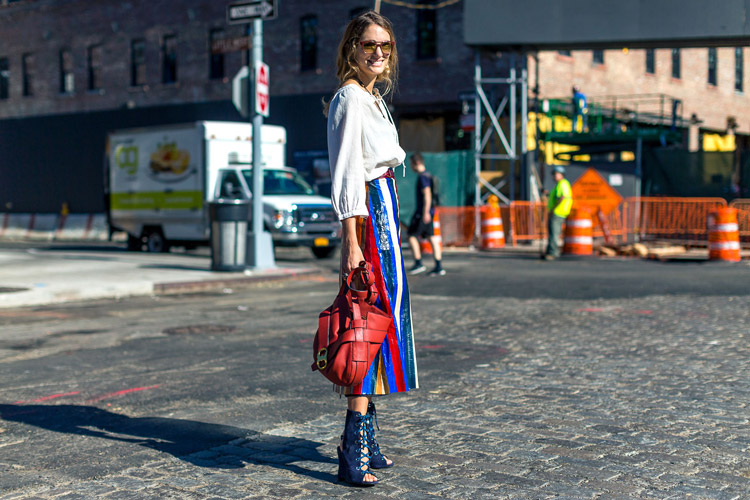 Модель в разноцветной юбке миди, белая блуза и синие ботильоны с открытым носом - уличная мода Нью-Йорка весна/лето 2017