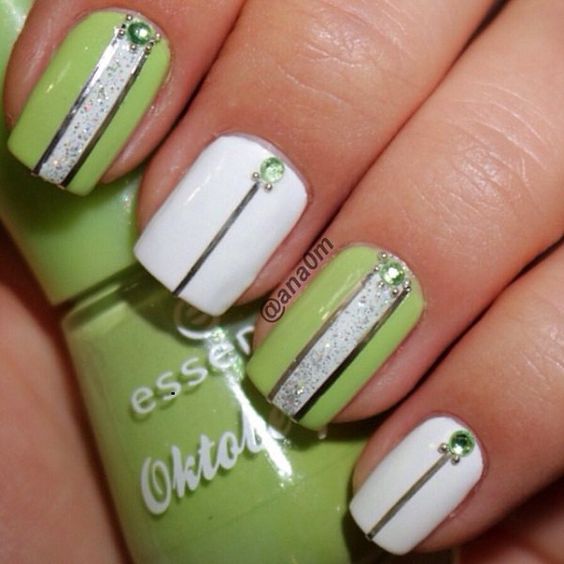 Green and white nail polish combination with silver aluminum lines, silver dust and green beads added on top.
