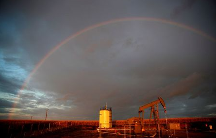 A rainbow is seen over a pumpjack during sunset outside Scheibenhard, near Strasbourg, France, October 6, 2017. REUTERS/Christian Hartmann