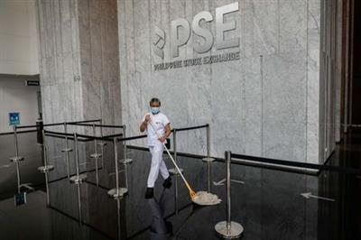 A janitor wearing a face mask cleans the lobby of the Philippine Stock Exchange amid the coronavirus disease (COVID-19) outbreak, in Taguig City, Metro Manila, Philippines, September 30, 2020. REUTERS/Eloisa Lopez
