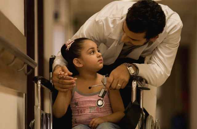 Doctor cheering his young patient