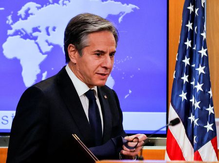 Newly confirmed U.S. Secretary of State Antony Blinken removes his face mask as he arrives to hold his first press briefing at the State Department in Washington, U.S., January 27, 2021. REUTERS/Carlos Barria/Pool 