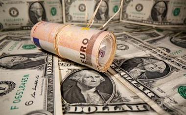 Rolled Euro banknotes are placed on U.S. Dollar banknotes in this illustration taken May 26, 2020. REUTERS/Dado Ruvic/Illustration/File Photo 