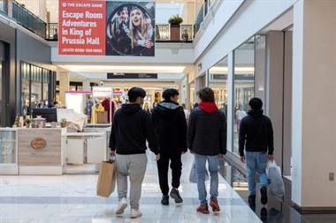 FILE PHOTO: People carrying shopping bags walk inside the King of Prussia shopping mall, as shoppers show up early for the Black Friday sales, in King of Prussia, Pennsylvania, U.S. November 26, 2021. REUTERS/Rachel Wisniewski/File Photo