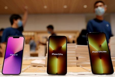 FILE PHOTO: Apple's iPhone 13 models are pictured at an Apple Store on the day the new Apple iPhone 13 series goes on sale, in Beijing, China September 24, 2021. REUTERS/Carlos Garcia Rawlins
