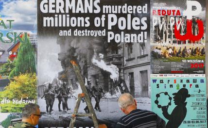 На фото: плакаты с требованием возмещения ущерба, нанесенного Германией во время Второй мировой войны, Варшава.