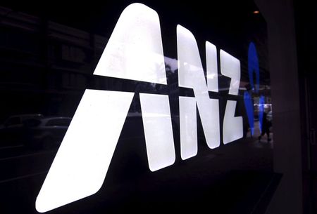 A man walks past a branch of the Australia and New Zealand Banking Group Ltd (ANZ) in Sydney October 29, 2013. REUTERS/David Gray/File Photo