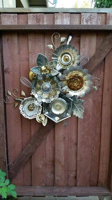  Fence garden art made from old metal serving dishes and other scraps.: 