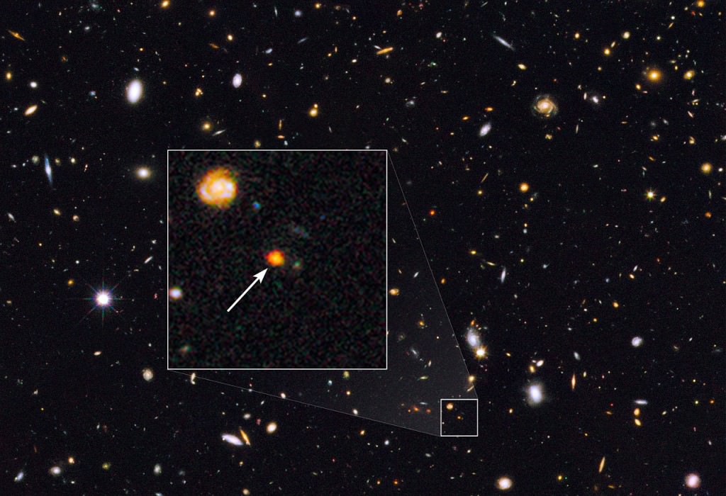 Галактическое <span>ядро <span>GOODS-N-774, обнаруженное в 2014 году посредством телескопа Hubble. На снимке в выделенном участке запечатлен свет миллионов новорожденных звезд в ранней Вселенной</span></span>