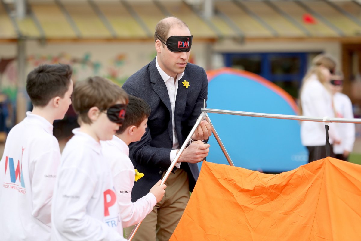 Prince William had more fun and games trying to put up a tent blindfolded in Abergevenny, Wales, while launching a children's award scheme.