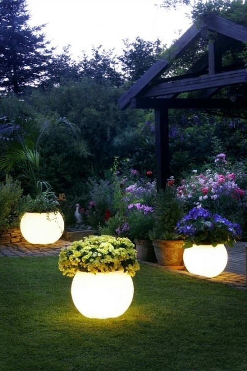 Coat planters with glow-in-the-dark paint for instant night lighting.