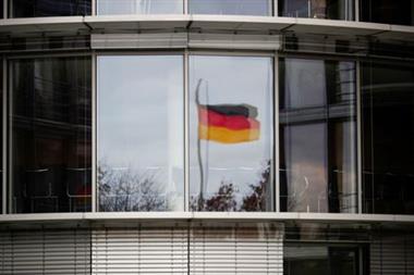 FILE PHOTO: A German flag is reflected in the window of the Paul Loebe building in Berlin, Germany, November 19, 2020. REUTERS/Hannibal Hanschke/File Photo