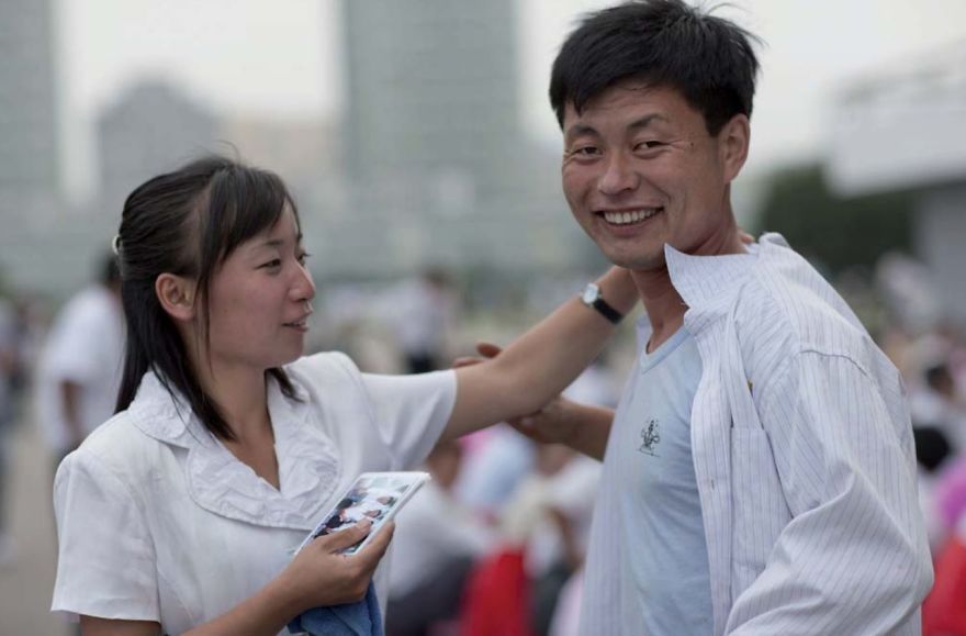 The Way You Dress Is Very Important In North Korea. In Town, You’ll Never Find Anybody Dressed Poorly. On This Day, Students Were Dancing In A Park. When I Asked To Take A Picture, The Girl Asked The Man To Straighten His Shirt