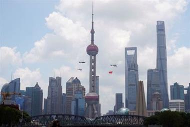 Aircraft fly in formation past Oriental Pearl Tower at Lujiazui financial district of Pudong on the 100th founding anniversary of the Communist Party of China, in Shanghai, China July 1, 2021. REUTERS/Aly Song 