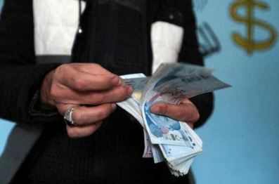 Hassan al-Khalaf, owner of al-Manar currency exchange bureau, counts Turkish lira banknotes inside his office in the opposition-held city of Idlib, Syria, December 4, 2021. Picture taken December 4, 2021. REUTERS/Khalil Ashawi