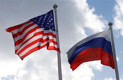 Russian and U.S. state flags fly near a factory of Ford Sollers, a joint venture of U.S. carmaker Ford with Russian partners, in Vsevolozhsk, Leningrad Region, Russia March 27, 2019. REUTERS/Anton Vaganov 