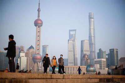People walk at the Bund, in front of Lujiazui financial district of Pudong, on the day of the opening session of the Chinese People's Political Consultative Conference (CPPCC), in Shanghai, China March 4, 2021. REUTERS/Aly Song 