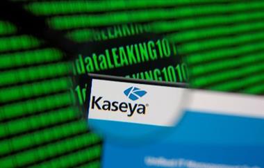 Kaseya's webpage is seen through magnifying glass in front of displayed binary code in this illustration taken, July 6, 2021. REUTERS/Dado Ruvic/Illustration
