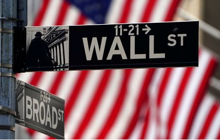 FILE PHOTO: A Wall Street sign is pictured outside the New York Stock Exchange in the Manhattan borough of New York City, New York, U.S., April 16, 2021. REUTERS/Carlo Allegri/File Photo